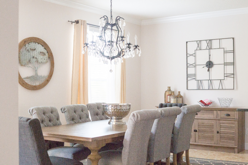 Dining room with a chandelier and upholstered chairs
