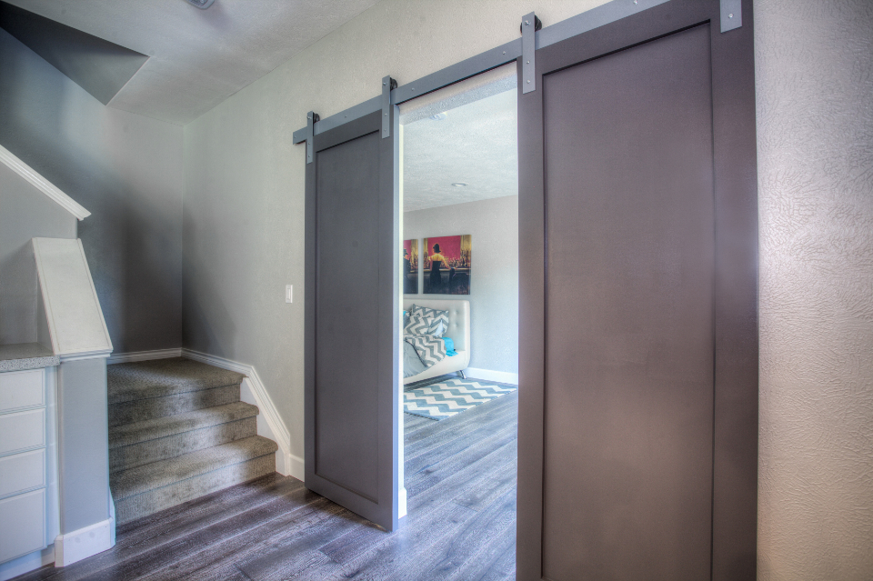 Staircase and landing with a white barn door